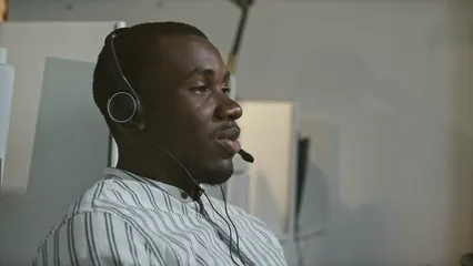 Horizontal video: Closeup video of a man playing with a baseball while in a call center office 5452727. Duration: 16 seconds. Resolution: 3840x2160