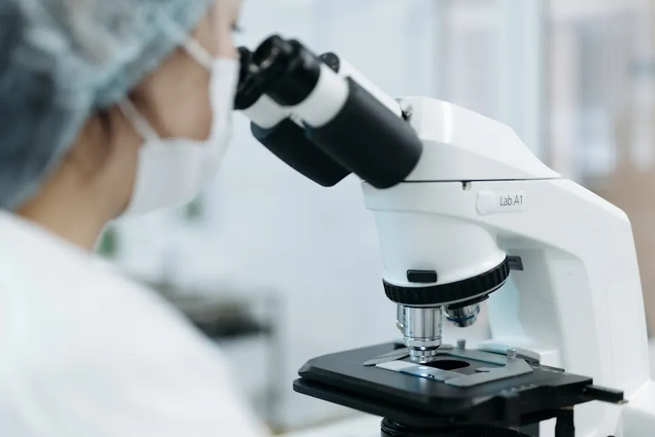 Medical Professional looking through a Medical Microscope
