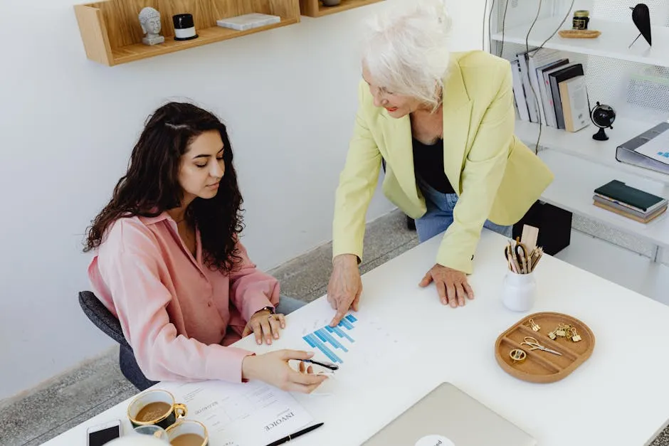 Women Looking at Statistics in an Office 