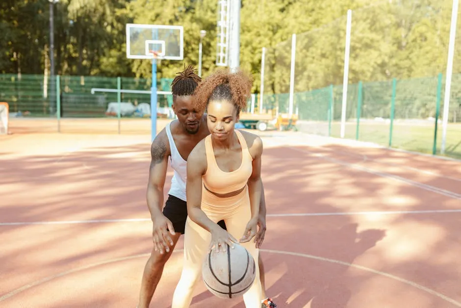 Man and Woman Playing Basketball in Basketball Court