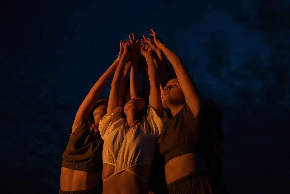 A Group of Women Looking Up while Raising Arms