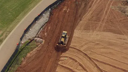 Horizontal video: A bulldozer leveling the soil in the construction site 5407518. Duration: 29 seconds. Resolution: 3840x2160
