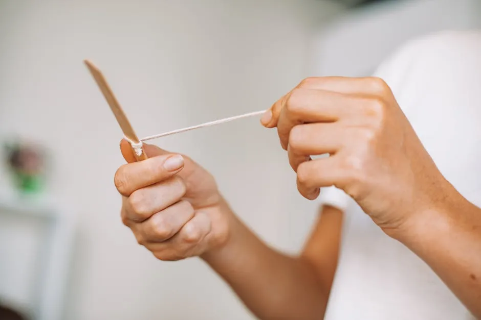 A Person Holding a Stick and a String