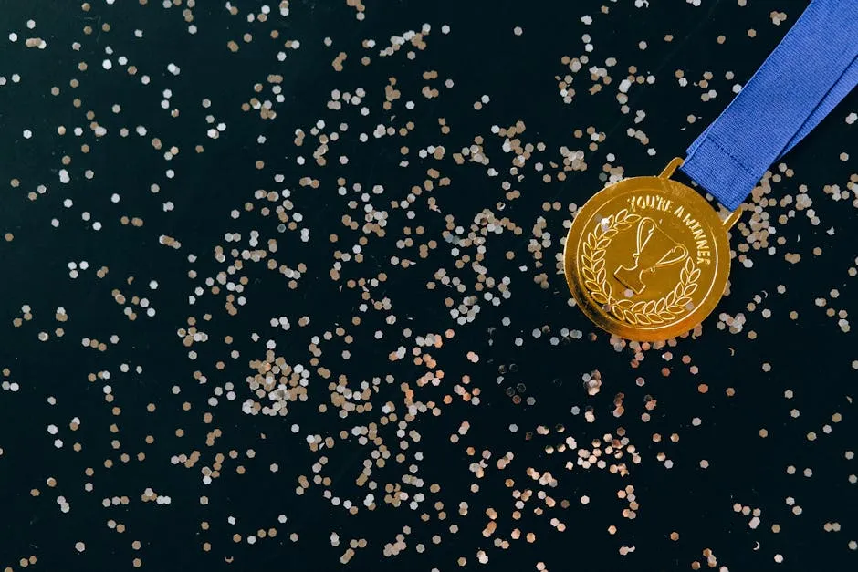 Close-Up Shot of a Gold Medal on a Black Surface