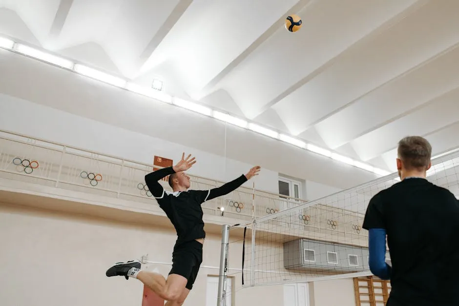 Volleyball Player in Black Shirt Spiking a Ball