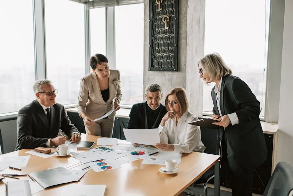 Business professionals engage in an office meeting to analyze data and strategies.