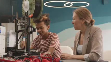 Horizontal video: A boy showing parts of his robot to his teacher 7868419. Duration: 29 seconds. Resolution: 3840x2160