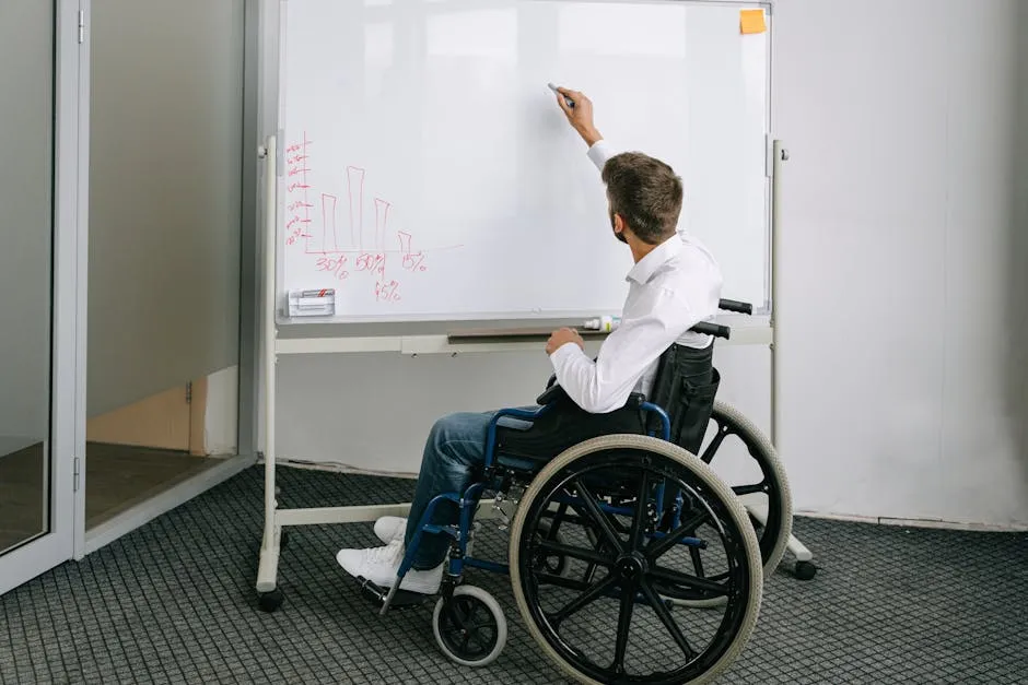 A Man on a Wheelchair Writing on a Whiteboard