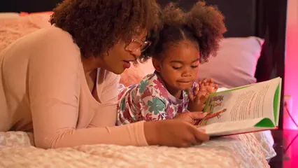 Horizontal video: Mother and daughter reading a book 10566593. Duration: 14 seconds. Resolution: 1920x1080