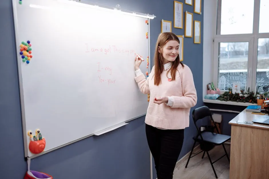 Woman Standing in Front of a Room Writing on Whiteboard