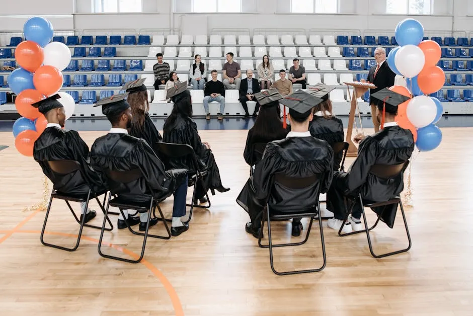 Photo of Graduates Sitting on a Folding Chair
