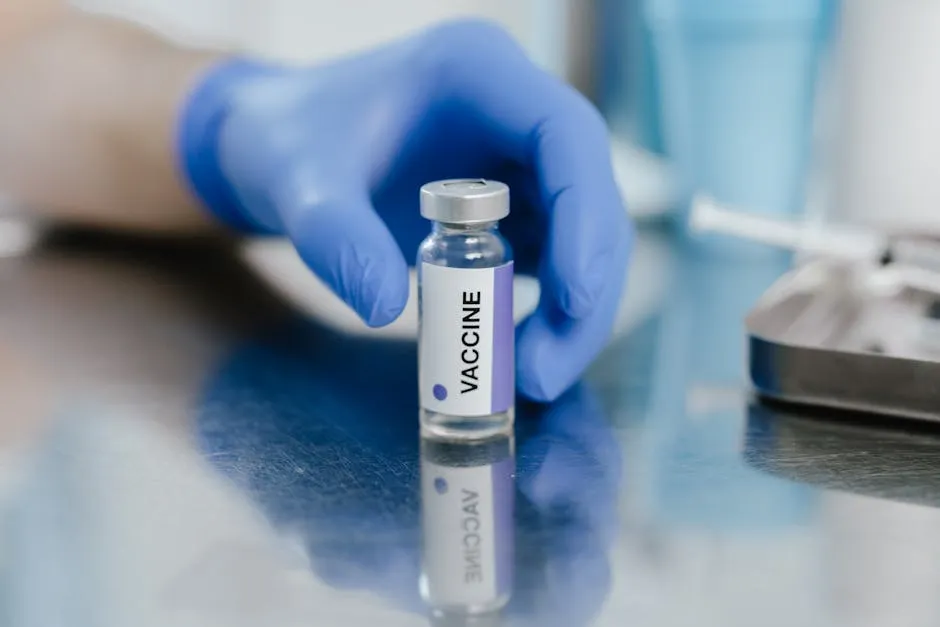 A Person with Blue Gloves Getting the Vaccine Vial