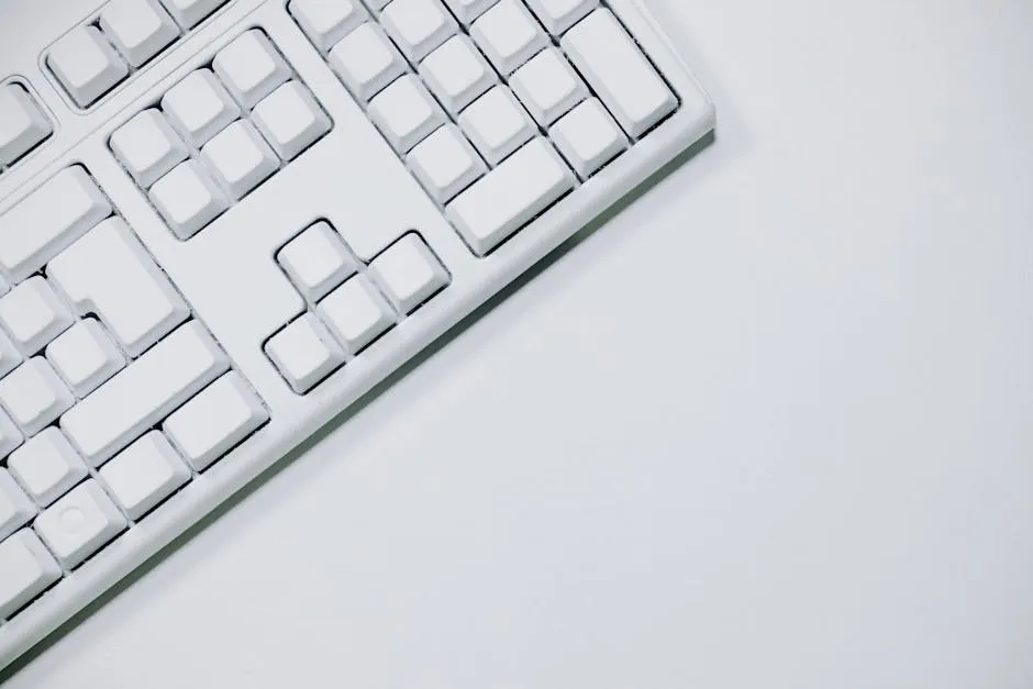 White Computer Keyboard on White Table