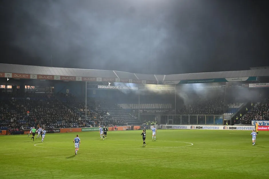 Football Stadium with Players in the Evening