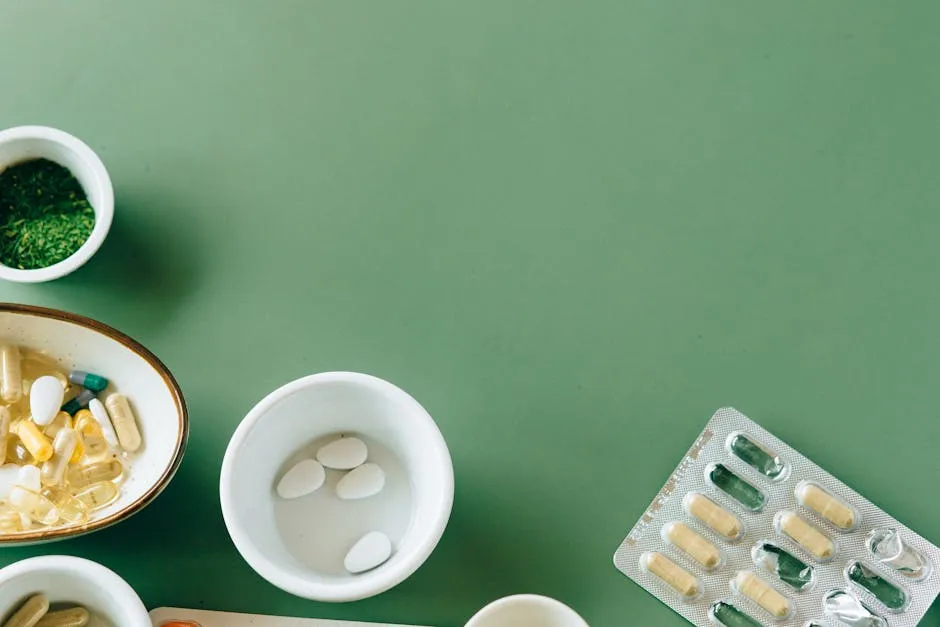 A flat lay of assorted pills and herbs on a green background emphasizing natural health remedies.