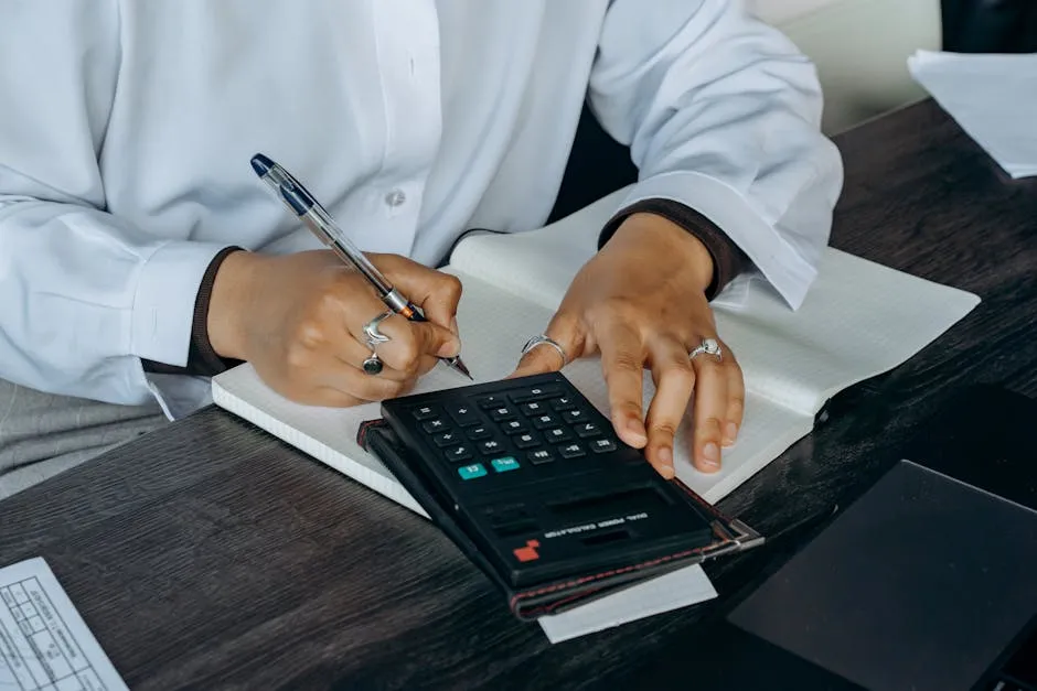 Person in White Long Sleeves Writing on a Notepad