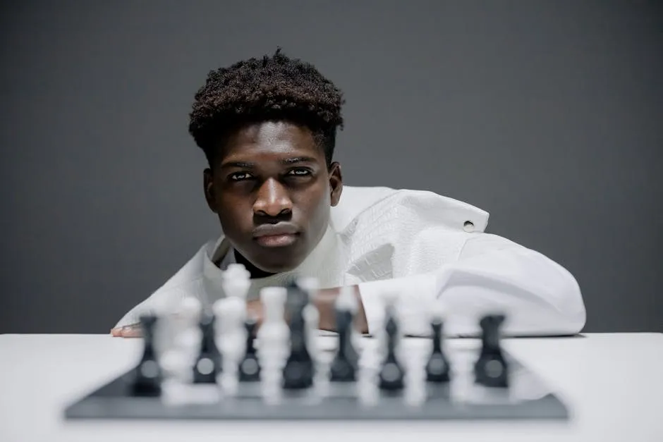 Man a White Top and a Chessboard on a White Table