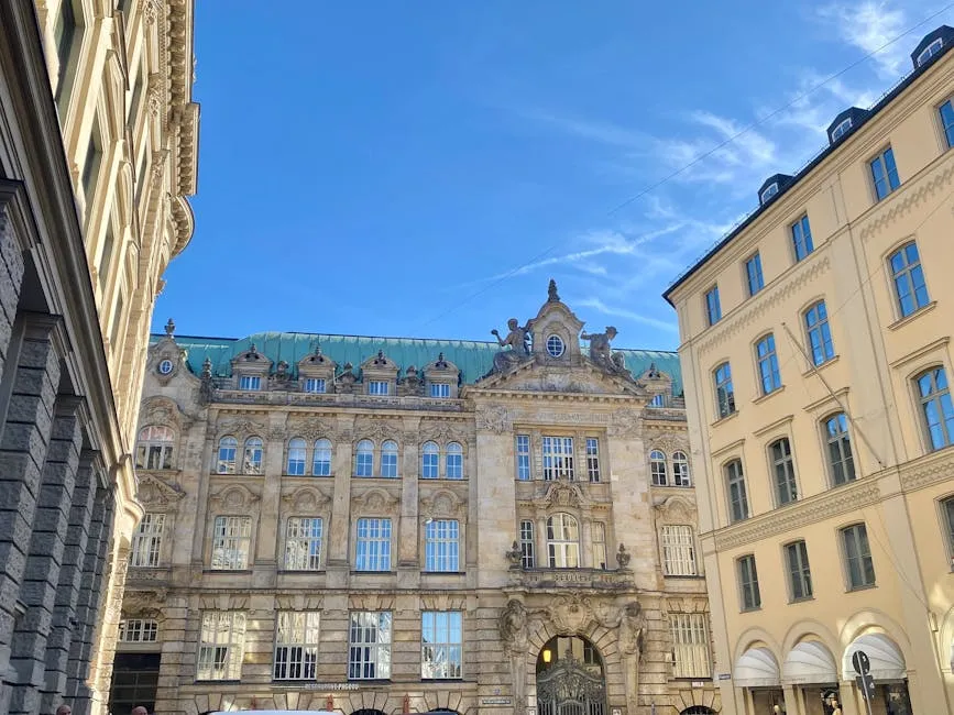 Beautiful historic architecture in downtown Munich under a clear blue sky.