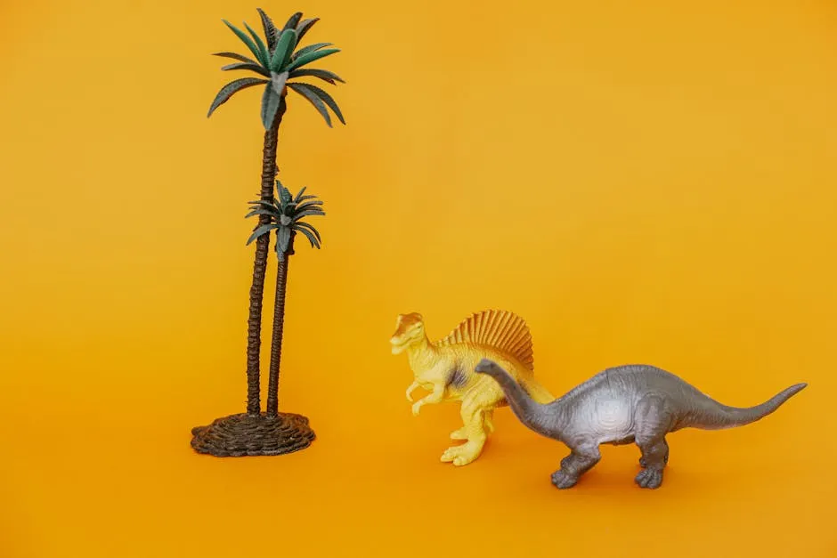 Colorful toy dinosaurs and palm trees on a vivid yellow backdrop, perfect for playful themes.