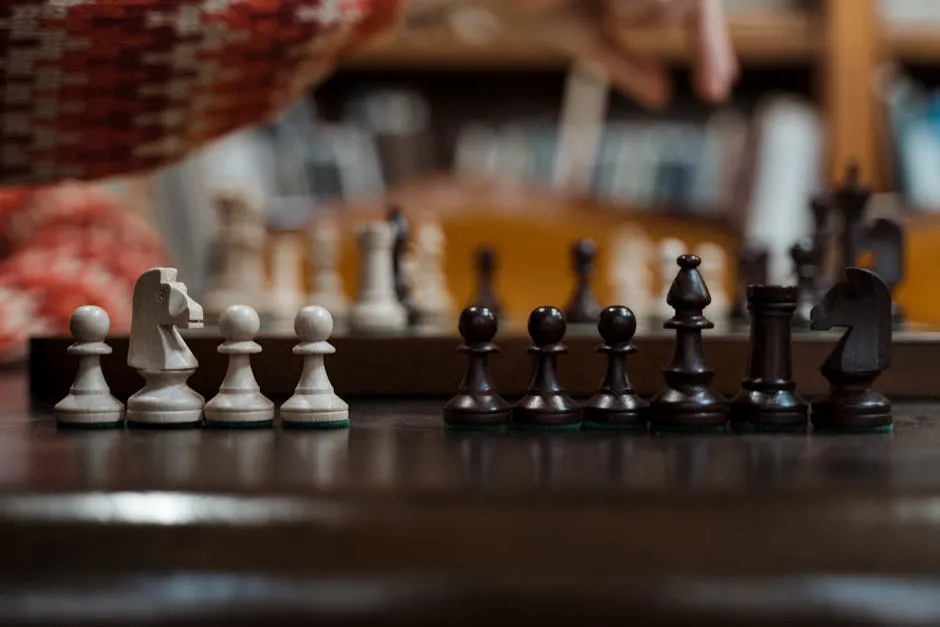 Close-up of chess pieces on a chessboard highlighting strategic play indoors.