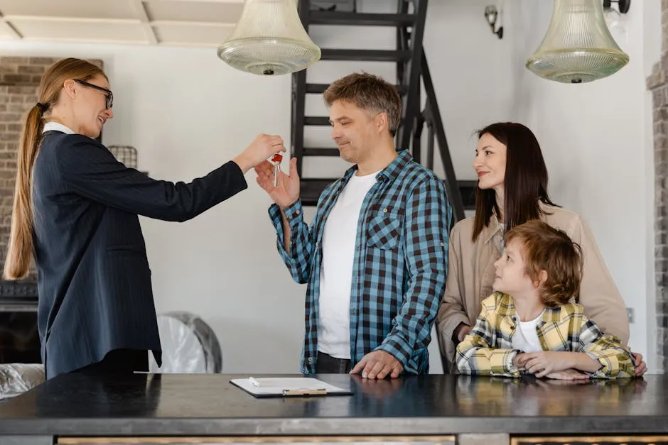 A realtor hands over the house keys to a joyful family in their new home.