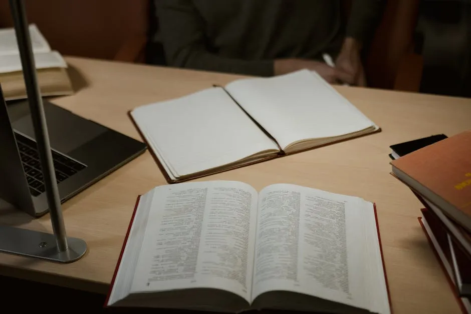 Notebook and Books on Wooden Desk